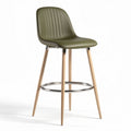 Green plastic bar stool with wooden legs and chrome footrest 44 inches high
